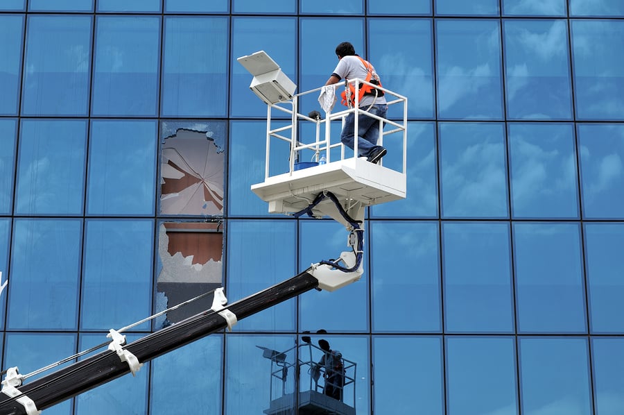 5 Types of Window Repairs We See, Lift operator breaks the windows of an office while cleaning them