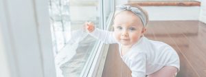 Little Crawling Baby Girl pointing at window